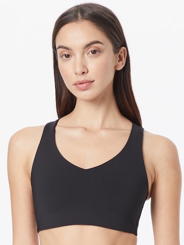 PUMA Bralette Sports Bra in Black: front