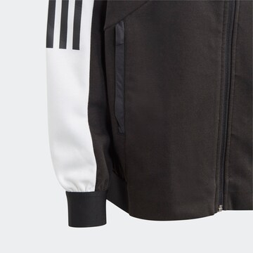 ADIDAS SPORTSWEAR Urheilutakki 'Tiro Suit Up ' värissä musta