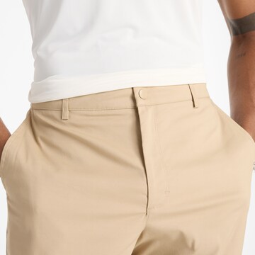 Regular Pantalon chino 'Athletics Standard Tapered' new balance en beige