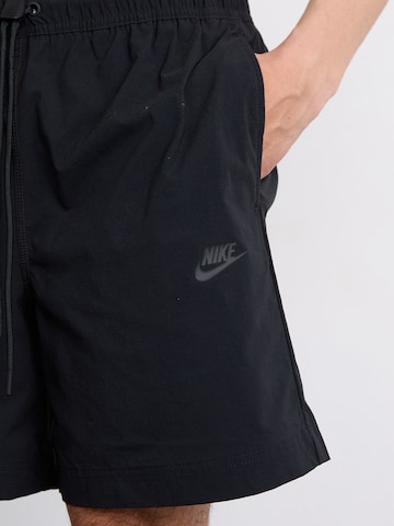 Nike Sportswear Loosefit Nadrág 'Tech' - fekete