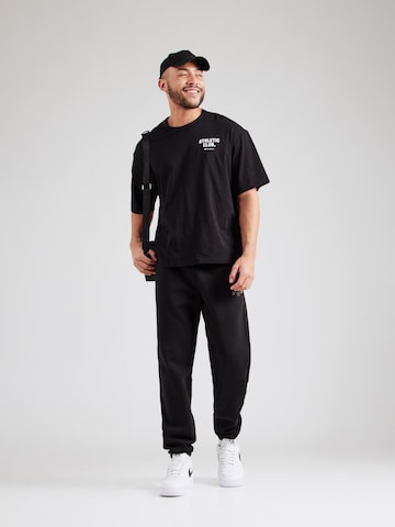 Champion Authentic Athletic Apparel - Tapered Pantalón en negro
