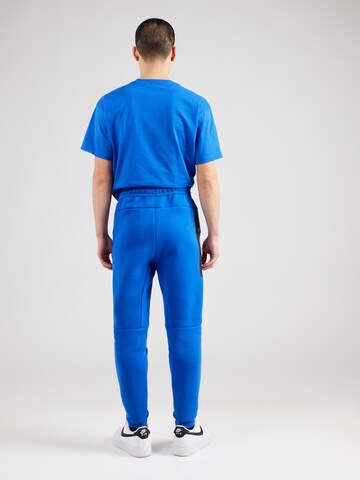 Nike SportswearTapered Hlače 'TCH FLC' - plava boja