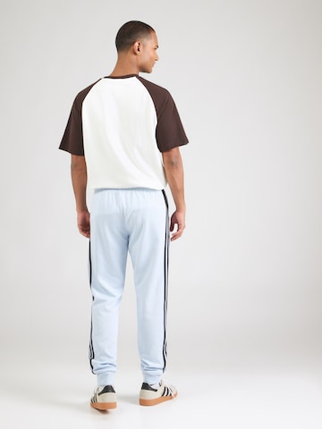 ADIDAS ORIGINALSTapered Hlače 'SST' - plava boja