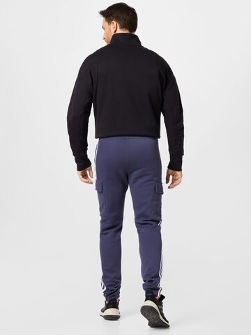 Tapered Pantaloni di ADIDAS ORIGINALS in blu