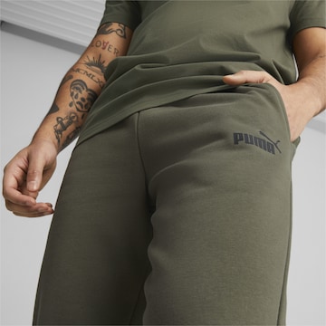 PUMA Tapered Sports trousers in Green