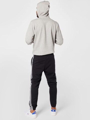 Effilé Pantalon de sport 'Essentials Fleece Tapered Elastic Cuff 3-Stripes' ADIDAS SPORTSWEAR en noir