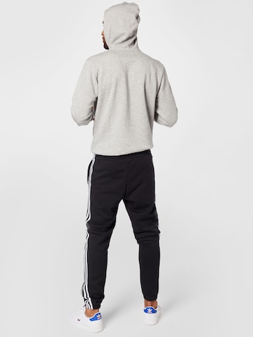 ADIDAS SPORTSWEAR Tapered Workout Pants 'Essentials Fleece Tapered Elastic Cuff 3-Stripes' in Black