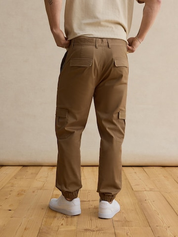 DAN FOX APPAREL Tapered Trousers 'Damon' in Beige