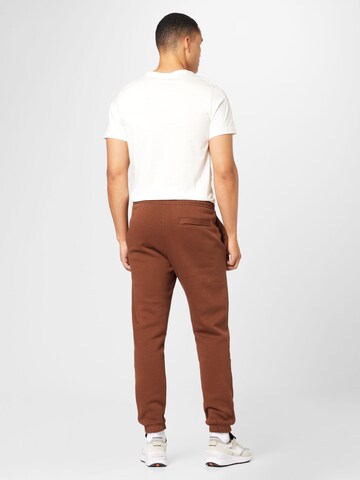 Nike Sportswear Zwężany krój Spodnie 'Club Fleece' w kolorze brązowy