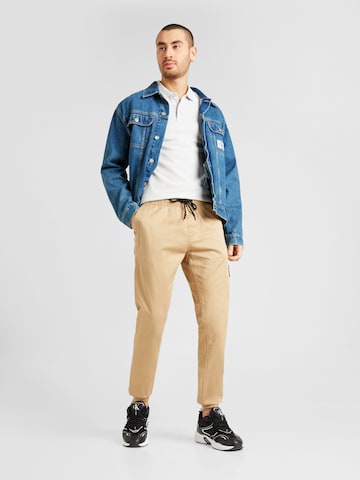smėlio Calvin Klein Jeans Siaurėjantis „Chino“ stiliaus kelnės