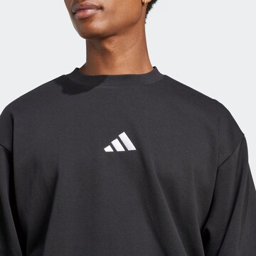 ADIDAS SPORTSWEAR Sportsweatshirt 'FEELCOZY' in Schwarz