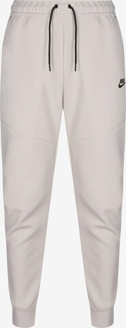 Nike Sportswear Tapered Pants in Beige: front