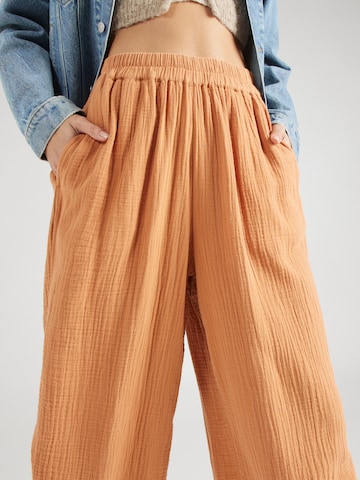 BILLABONG Zvonové kalhoty Kalhoty 'FOLLOW ME' – oranžová