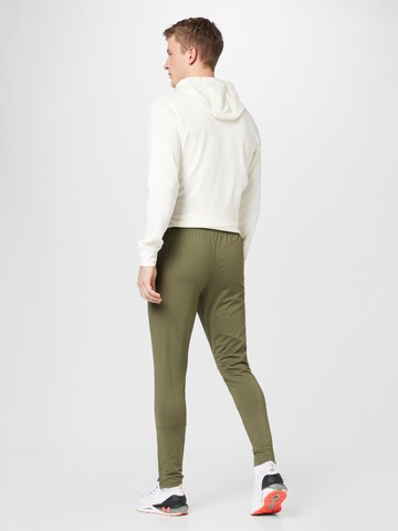 UNDER ARMOUR Slim fit Workout Pants 'Challenger' in Green