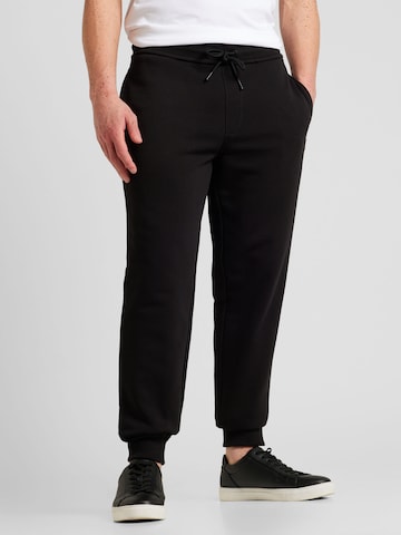 Calvin Klein Jeans - Tapered Calças em preto: frente