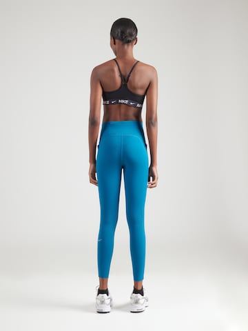 NIKE Kitsas Spordipüksid 'SWIFT', värv sinine: tagant vaates