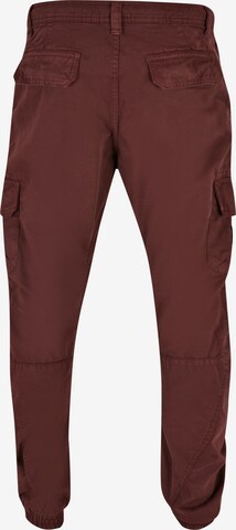 Tapered Pantaloni cargo di Urban Classics in rosso