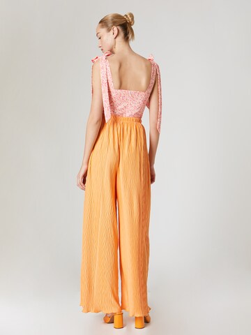 ABOUT YOU x Laura Giurcanu Loose fit Trousers 'Christin' in Orange