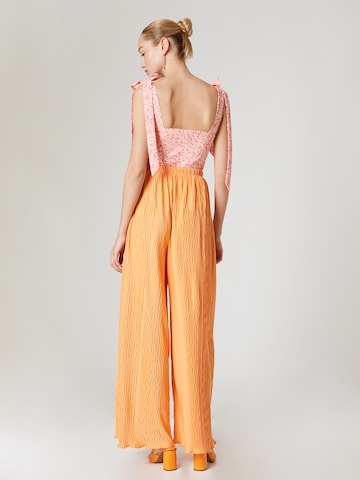 ABOUT YOU x Laura Giurcanu Loose fit Trousers 'Christin' in Orange