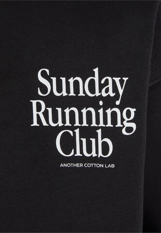 Another Cotton Lab Tréning dzseki 'Sunday Running Club' - fekete