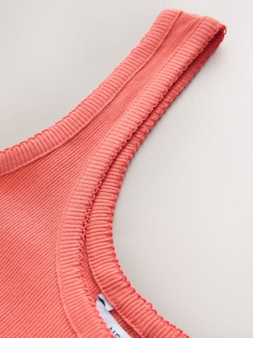 Next - Top en naranja