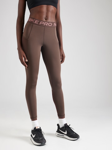 NIKE Skinny Sportbroek in Bruin: voorkant