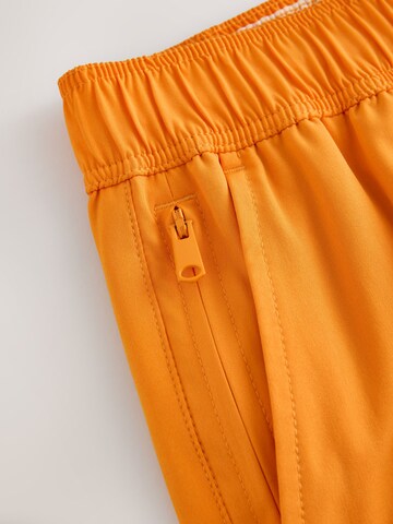 Next - Bermudas 'Motion-Flex' en naranja