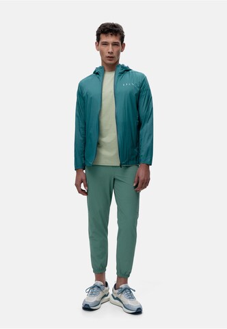 Born Living Yoga Tapered Weatherproof pants 'Minho' in Green