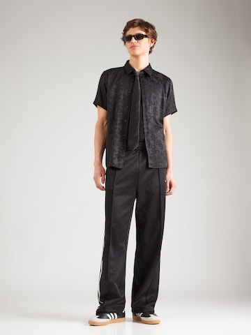 Carhartt WIP Zvonové kalhoty Kalhoty 'Bolar' – černá