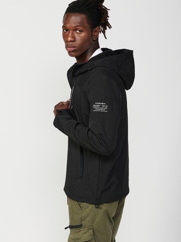 KOROSHI Välikausitakki värissä musta