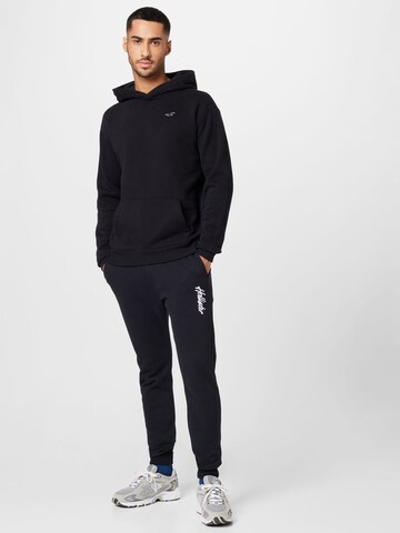 HOLLISTER - Tapered Calças em preto