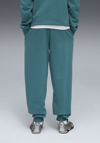 PUMA Tapered Sportbroek in Groen