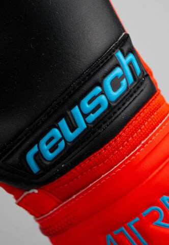 REUSCH Sports gloves 'Attrakt Freegel Silver' in Red