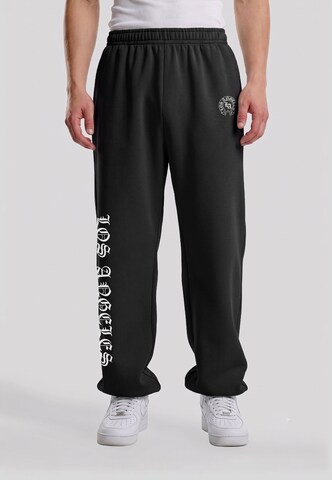 Effilé Pantalon 'LA Dynasty' Mister Tee en noir : devant