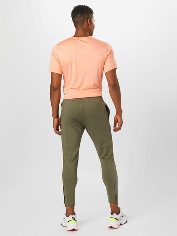 NIKE Slim fit Workout Pants in Green