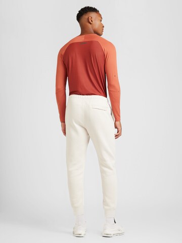 Tapered Pantaloni 'Club Fleece' de la Nike Sportswear pe bej