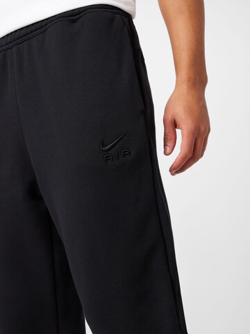 Nike Sportswear Tapered Housut 'Air' värissä musta