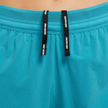 NIKE Regular Weatherproof pants in Blue