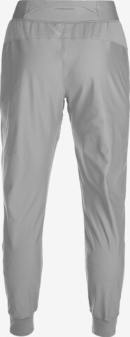 Effilé Pantalon de sport UNDER ARMOUR en gris