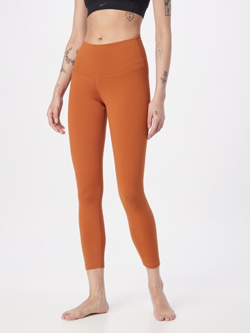 NIKE Skinny Workout Pants in Orange: front