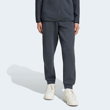 ADIDAS ORIGINALS Tapered Pants in Grey: front