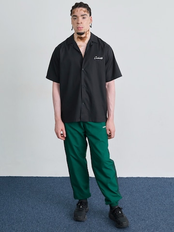 ADIDAS ORIGINALS Tapered Trousers in Green