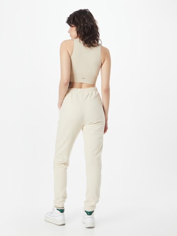 Tapered Pantaloni sportivi di aim'n in beige