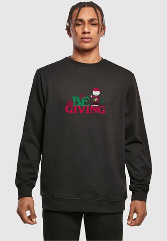 Merchcode Sweatshirt 'Peanuts Be Giving' in Zwart: voorkant
