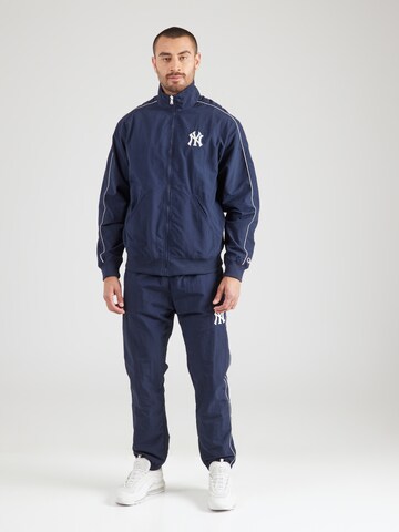 Champion Authentic Athletic Apparel Tracksuit in Blue: front