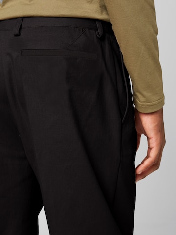 ABOUT YOU x Alvaro Soler Regular Trousers with creases 'Emir' in Black