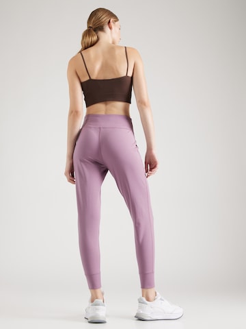 UNDER ARMOUR Tapered Sports trousers 'Motion' in Purple