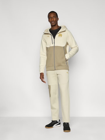 PUMA Szabványos Sportnadrágok 'OM PUMATECH' - bézs