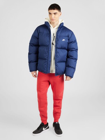 Nike Sportswear Zúžený Kalhoty 'TECH FLEECE' – červená