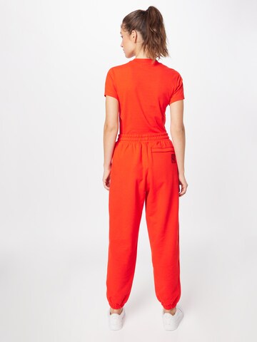 PUMA Tapered Broek in Oranje